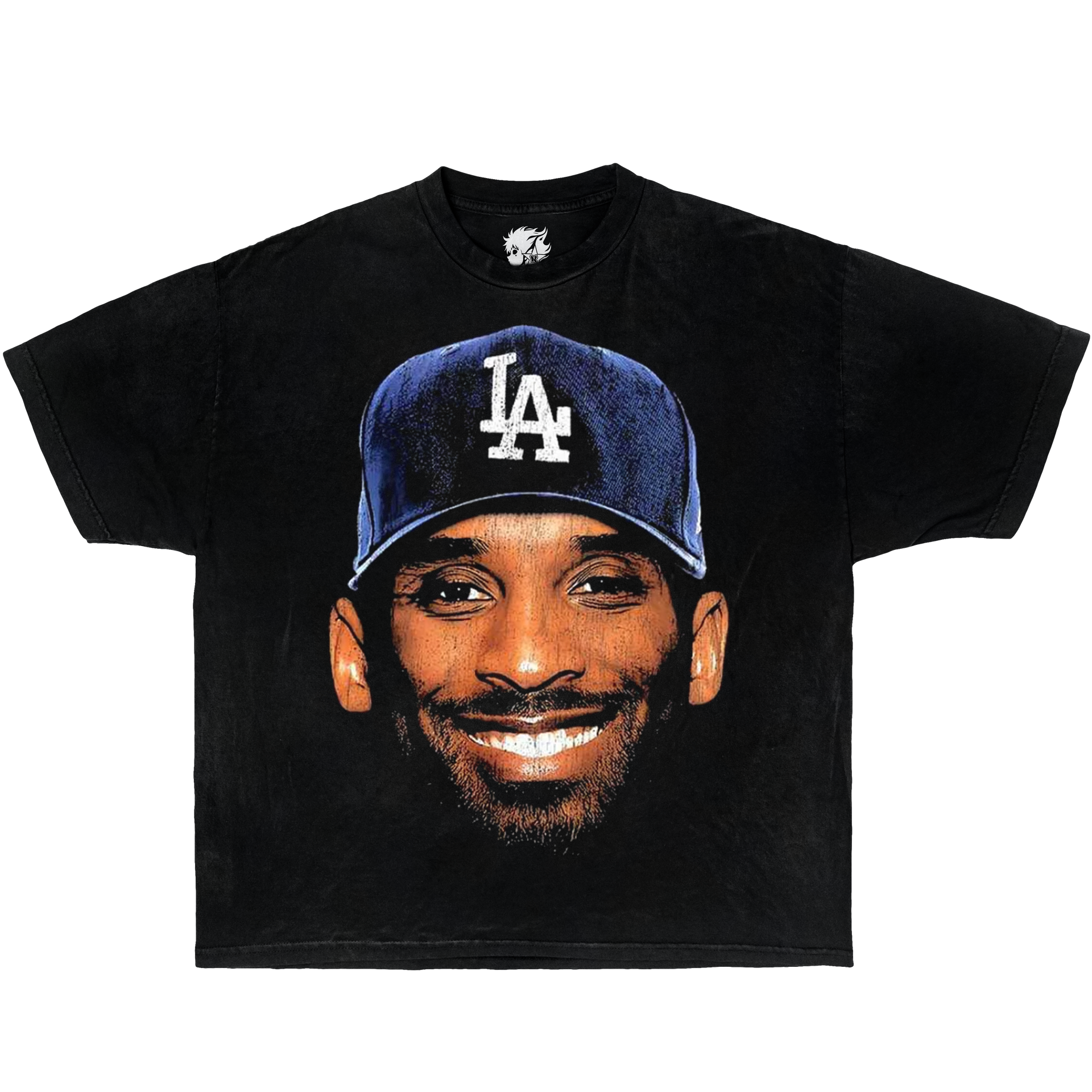 Black t-shirt with a graphic of Kobe Bryant wearing a blue LA Dodgers cap on a white background. Vintage Oversized Boxy Shirt Of Kobe Bryant
