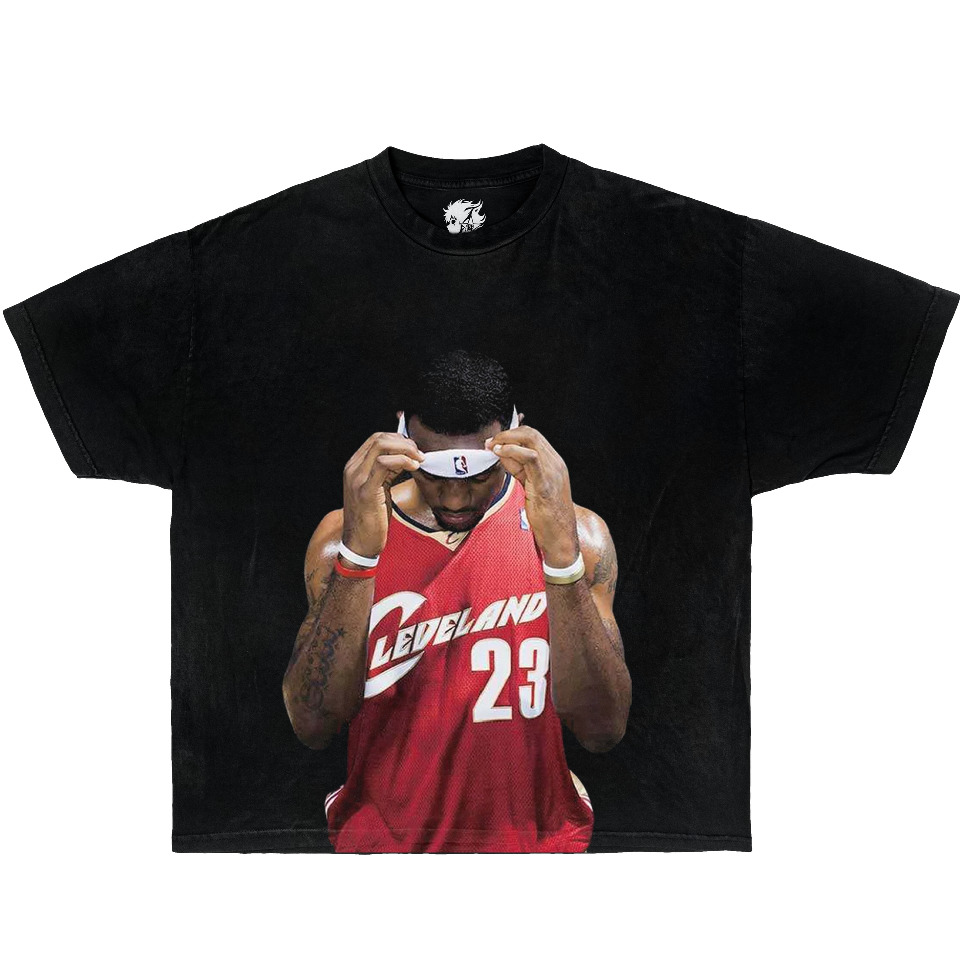 Black t-shirt with a graphic of Lebron James basketball player in a red jersey on a white background. Vintage Oversized Boxy Shirt Of Lebron James Rookie On Cleveland.