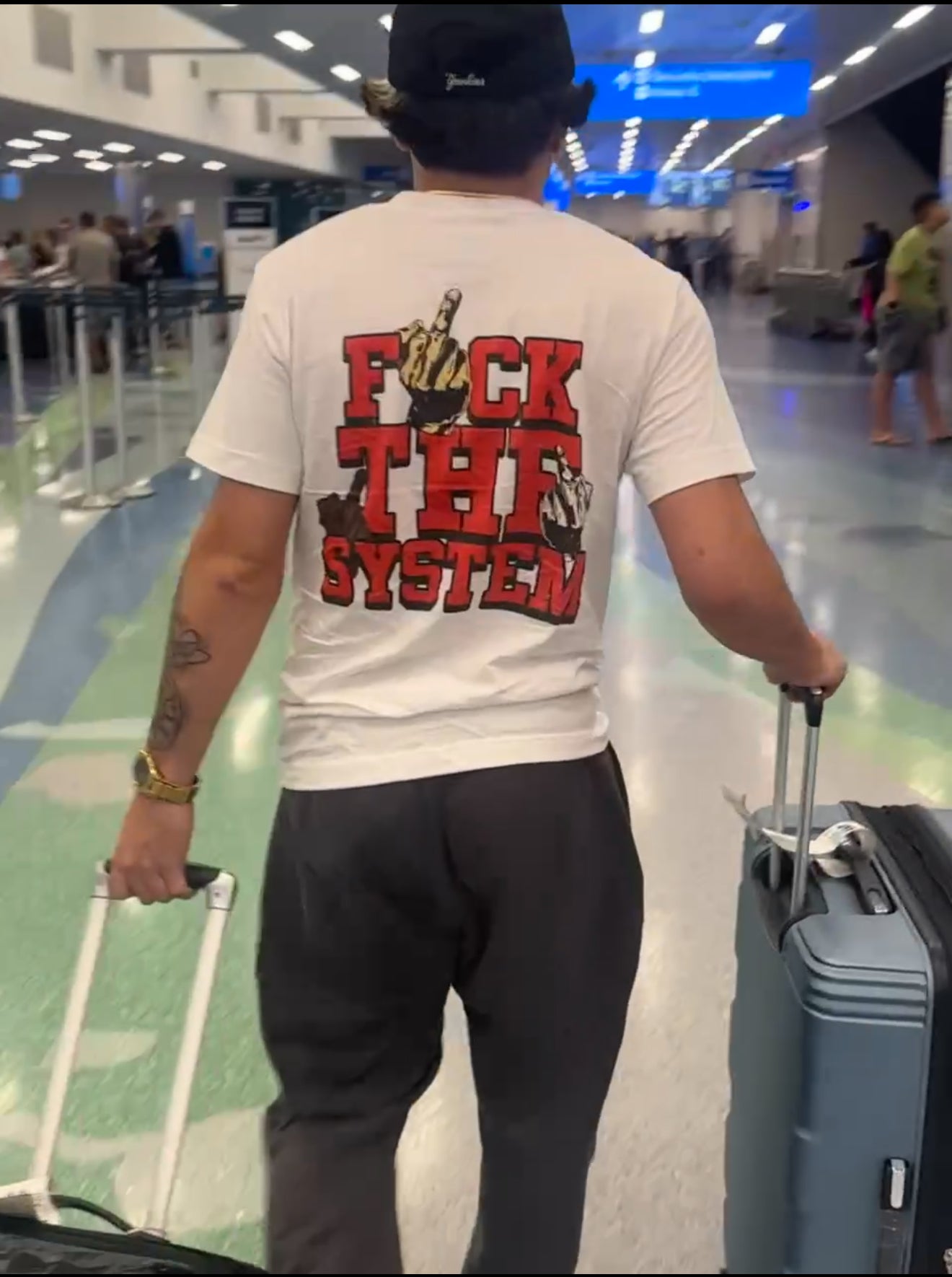 Person wearing a t-shirt with a graphic design in an airport

anti system streetwear shirt

hype streetwear oversized graphic