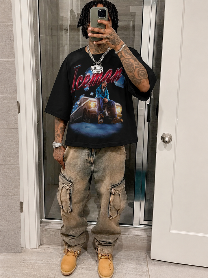 Person wearing a black t-shirt with a graphic design and beige pants, standing in a room. Drake Iceman Art Boxy Shirt Vintage Bootleg Streetwear Oversized Graphic Tee
