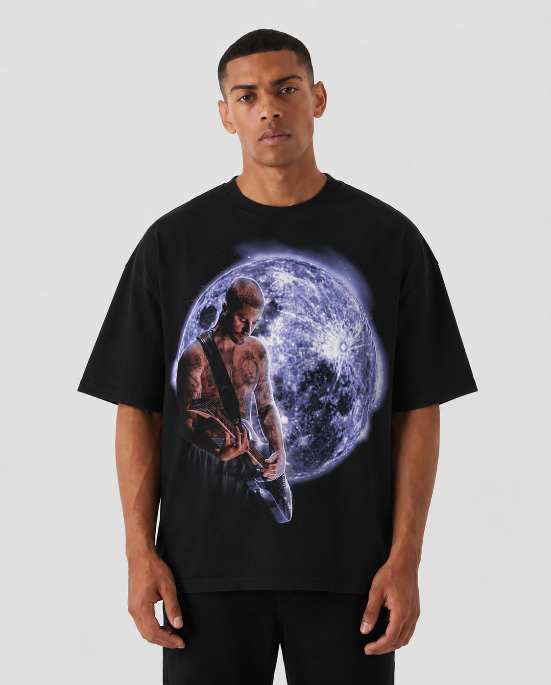 Person wearing a black t-shirt with a graphic design of a person playing guitar against a moon background. Justin Bieber Guitar Dream Boxy Shirt Vintage Streetwear Oversized Graphic Tee
