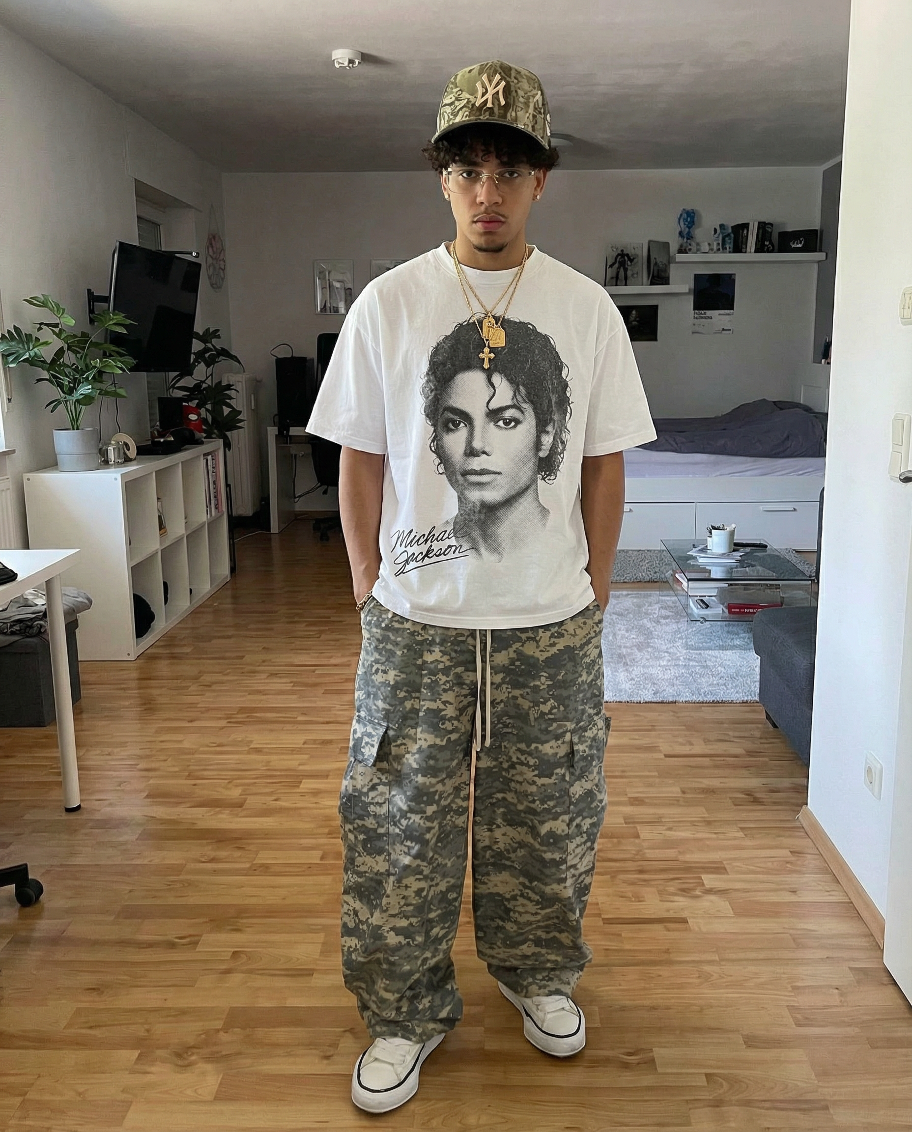 Person wearing a Michael Jackson t-shirt and camouflage pants in a living room.