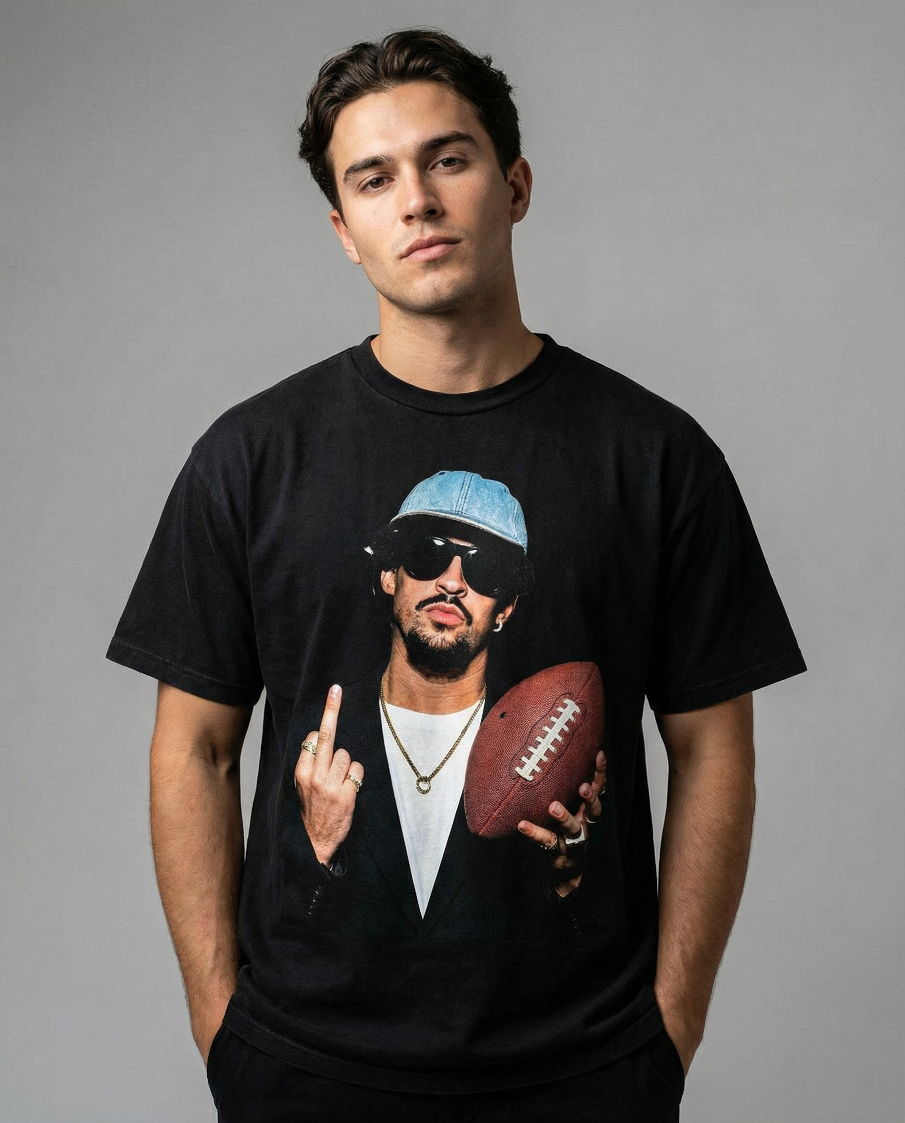 Man wearing a black t-shirt with a graphic design on a gray background