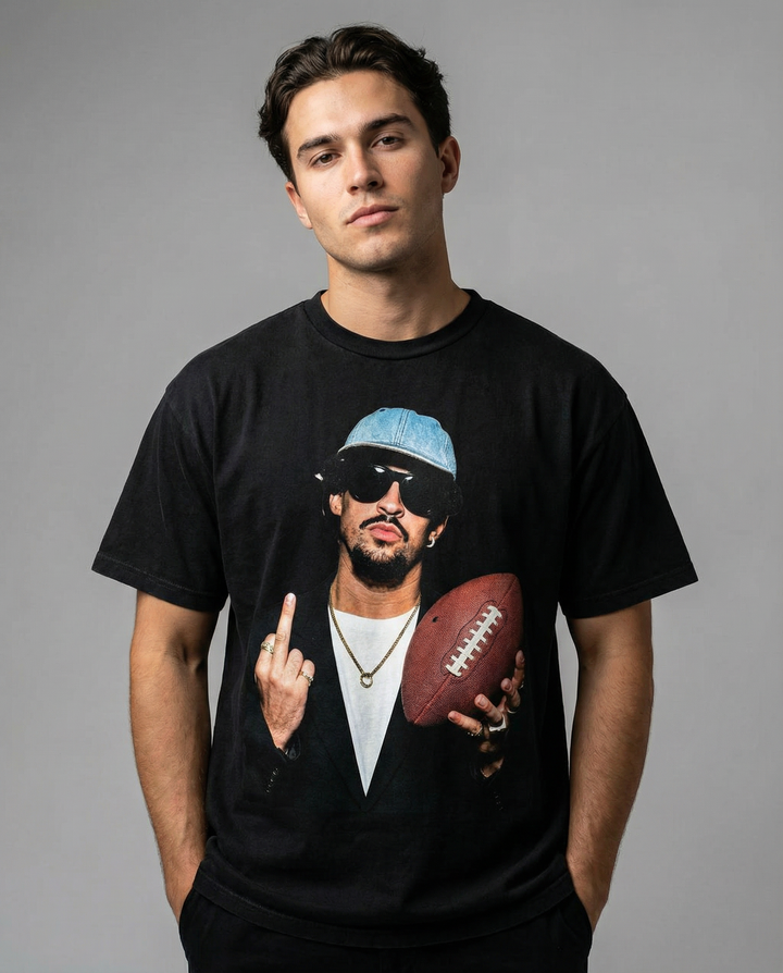 Man wearing a black t-shirt with a graphic design on a gray background