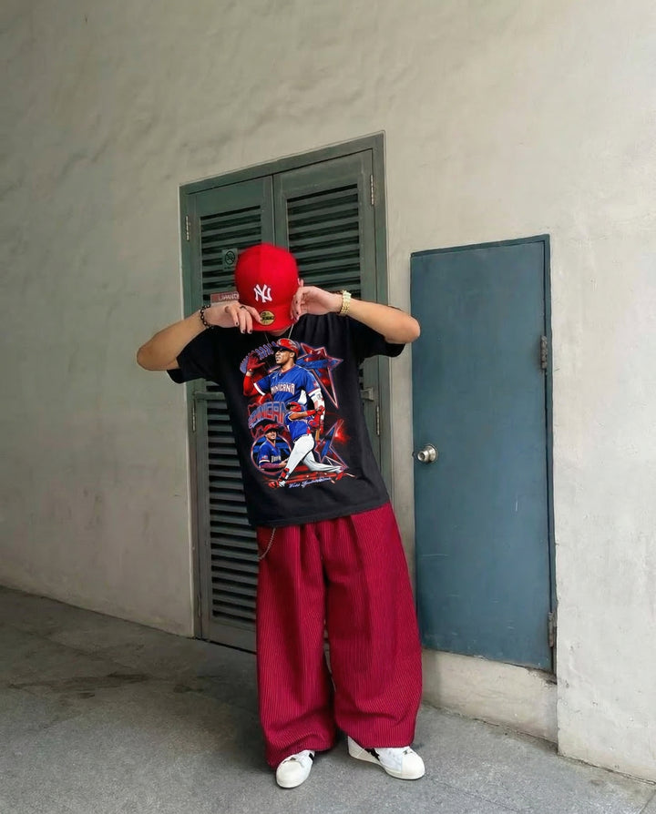 Dominican Dynasty vintage baseball tee, black oversized graphic t-shirt worn by a model with a red NY cap.