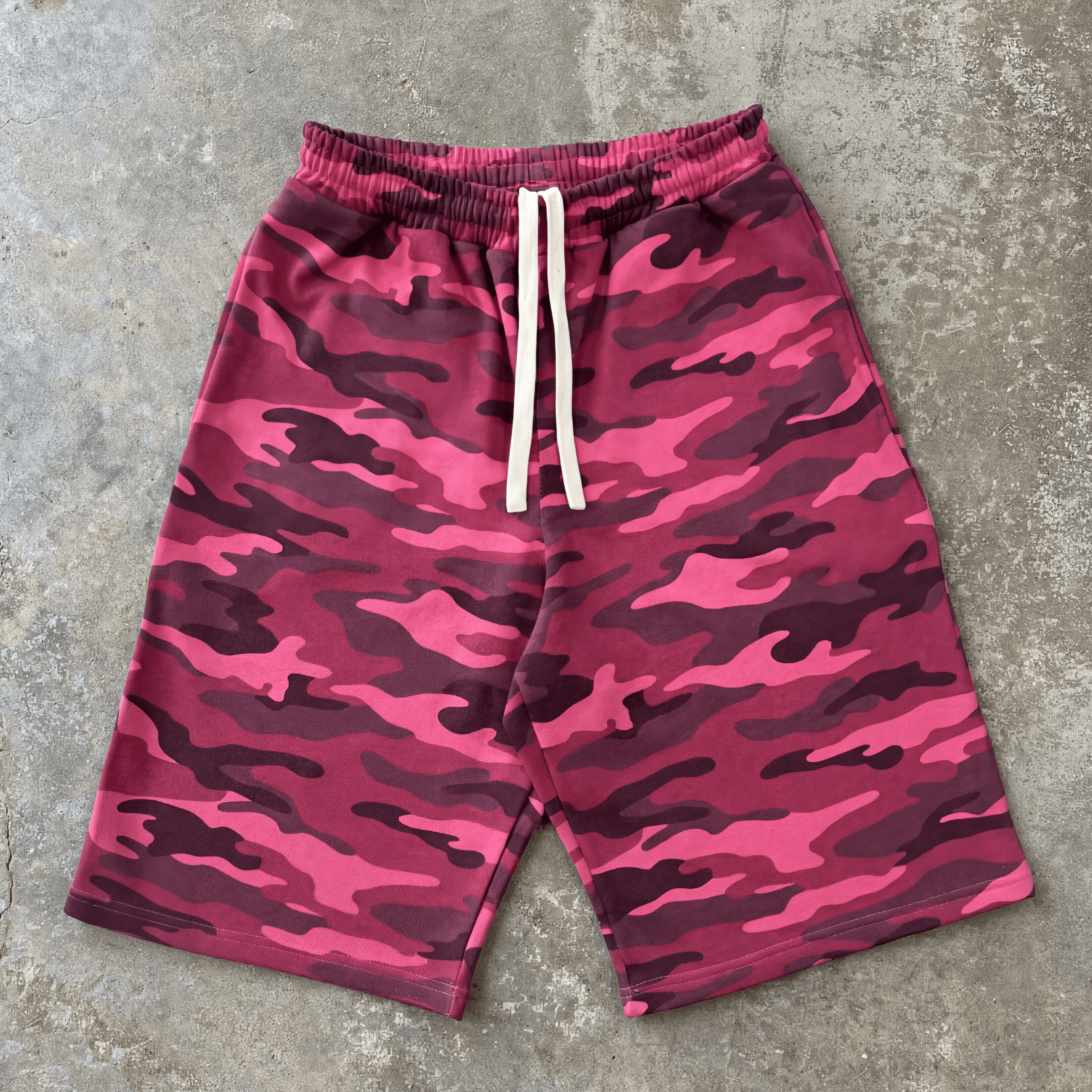 Pink camouflage shorts on a gray concrete surface