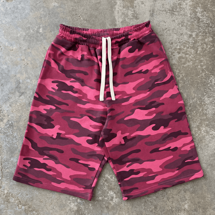 Pink camouflage shorts on a gray concrete surface