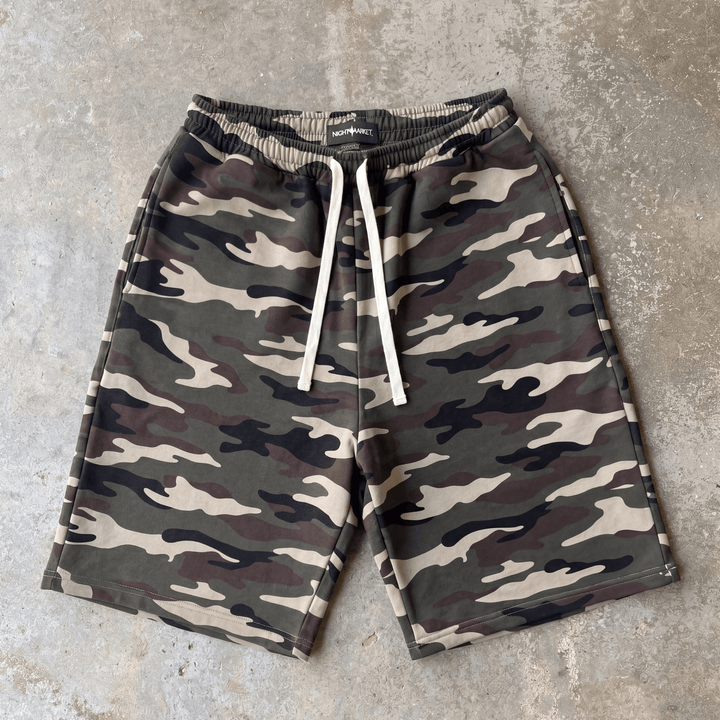 Camouflage shorts with drawstring on a concrete surface