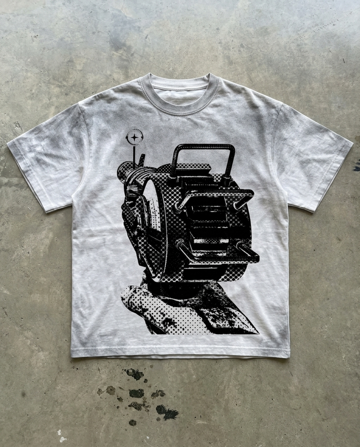 White t-shirt with black graphic design on a concrete surface